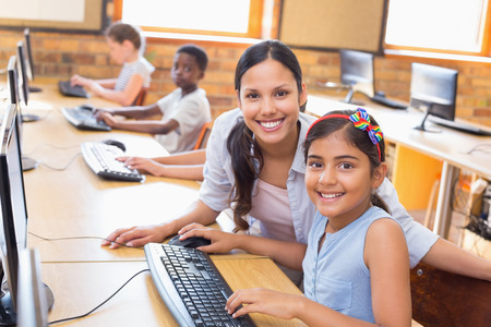 38078035 – cute pupils in computer class with teacher at the elementary school
